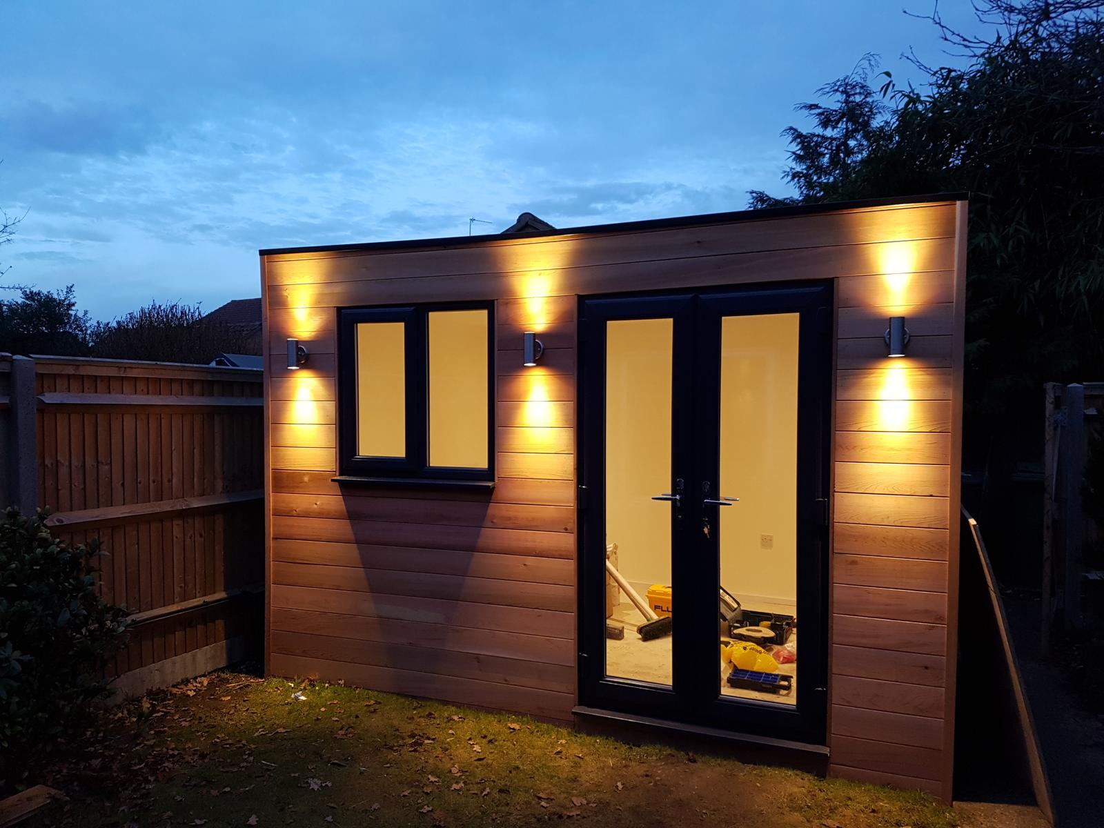 Timber-clad garden office with anthracite French doors